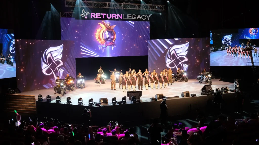 Performers lined up beside motorcycles on the Auditorium stage at a Return Legacy recognition night