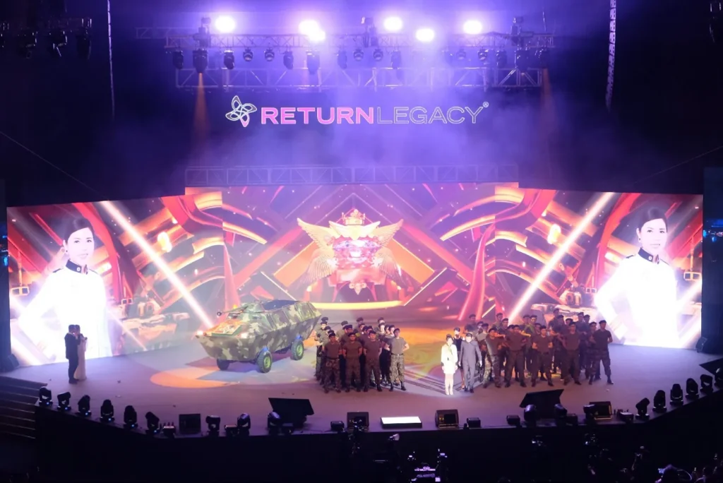 Performers in uniform and a military vehicle prop on the Auditorium stage at a Return Legacy recognition night
