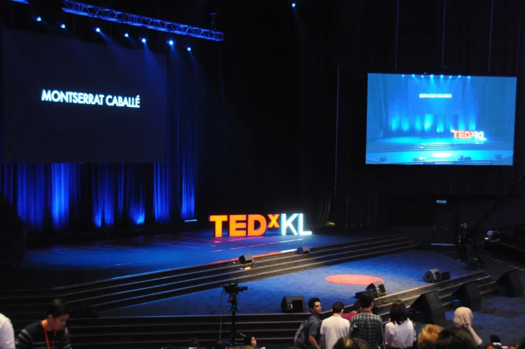 TEDxKL stage set in the Auditorium, lit in blue before a talk
