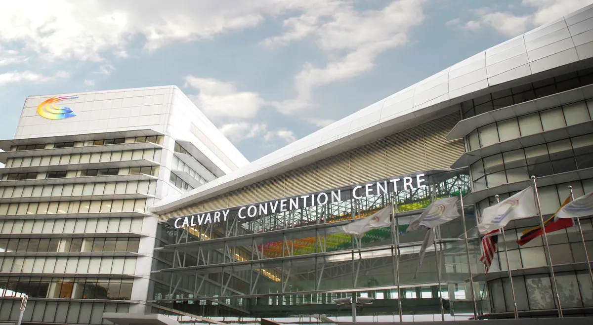 Front of Calvary Convention Centre with its name sign and flags