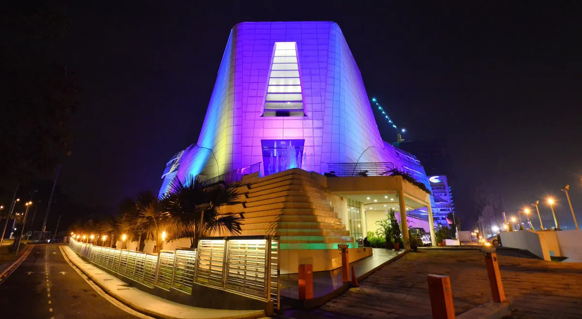 Calvary Convention Centre tower lit in purple and blue at night