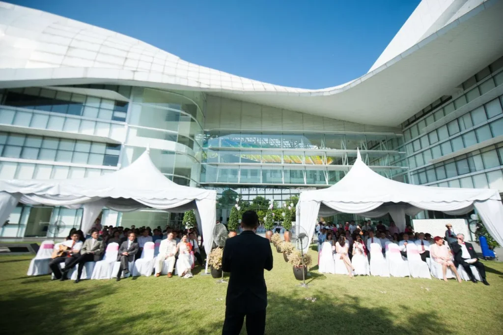 Wedding guests seated under white tents on the Garden lawn