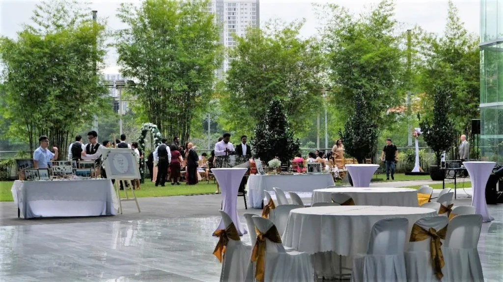 Wedding reception tables with gold sashes on the terrace beside the Garden