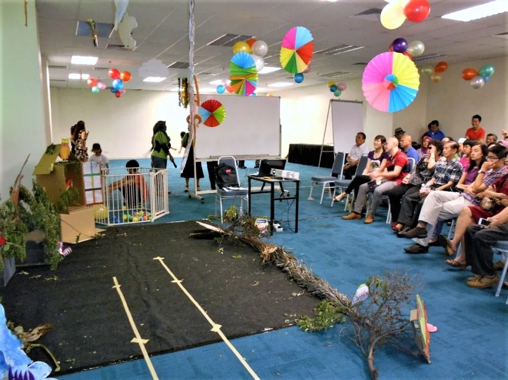 Stage props and parents' seating set up for a kindergarten performance in a meeting room