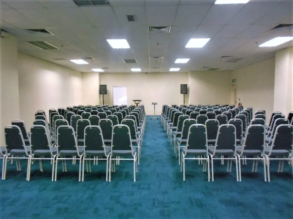 Theatre-style rows of chairs with a centre aisle in a meeting room