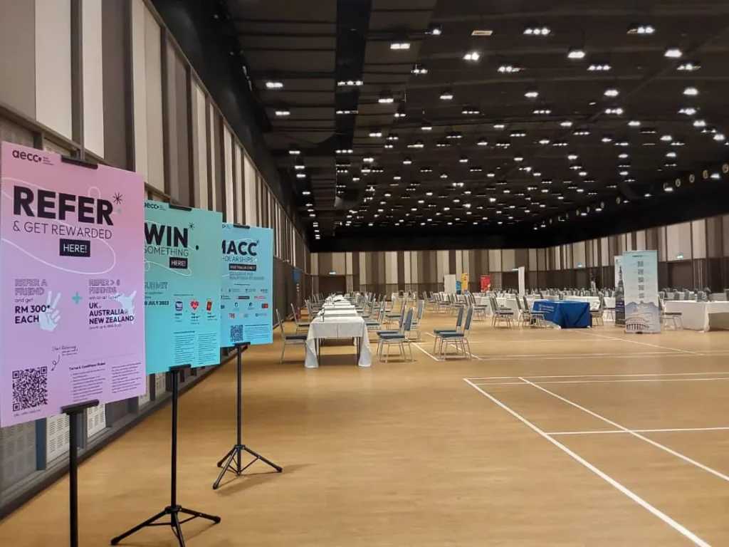 Education fair banners and exhibitor tables across the Multipurpose Banquet Hall