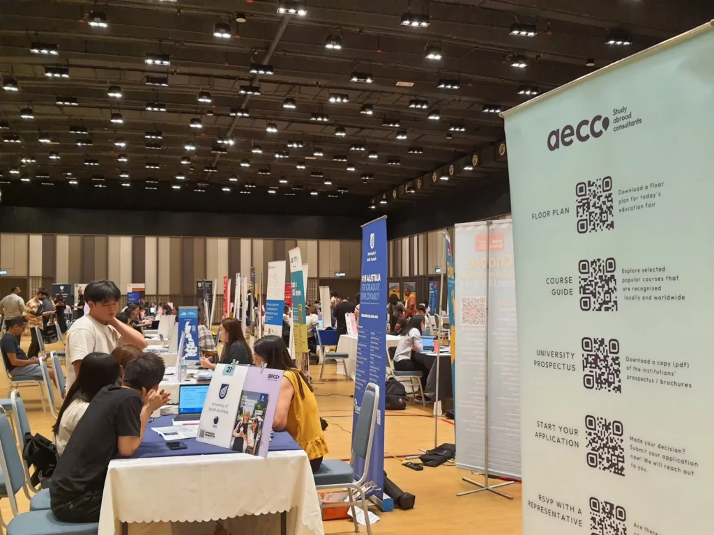 Students talking to university counsellors at an AECC education fair in the Multipurpose Banquet Hall