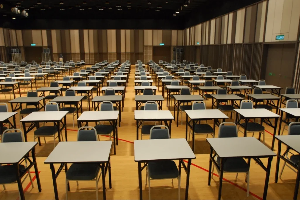Rows of single desks and chairs set up for an examination in the Multipurpose Banquet Hall