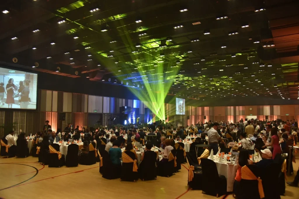 Green laser lights above guests at a dinner gala in the Multipurpose Banquet Hall