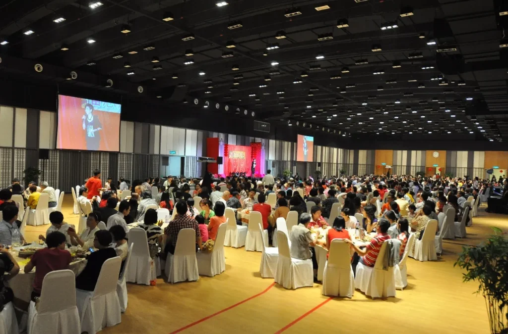 Singer shown on the big screen at a dinner gala in the Multipurpose Banquet Hall
