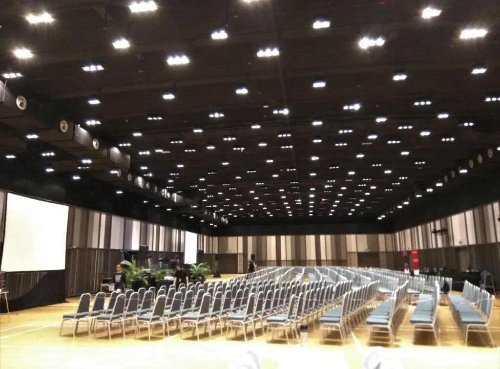 Rows of chairs under the high ceiling lights of the Multipurpose Banquet Hall
