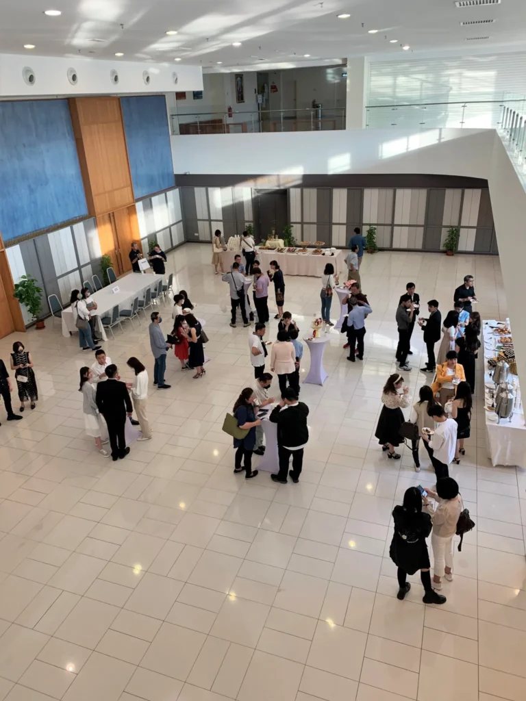 Guests standing and talking near buffet tables in the Multipurpose Banquet Hall lobby