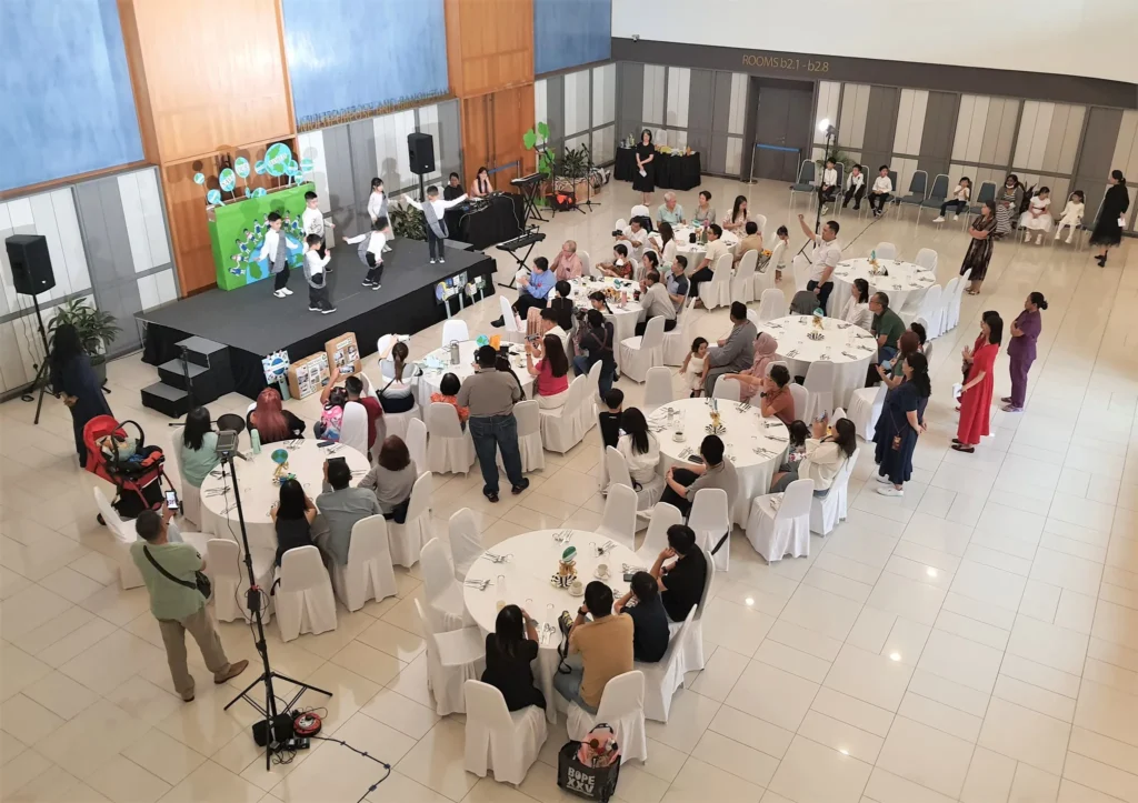 Kindergarten graduation ceremony in the Multipurpose Banquet Hall lobby, with families at round tables