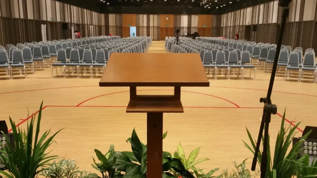 View from behind a wooden podium over rows of chairs in the Multipurpose Banquet Hall