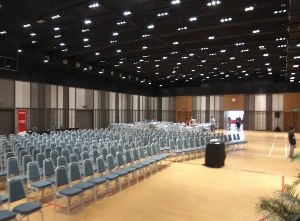 Side view of rows of blue chairs set for an event in the Multipurpose Banquet Hall