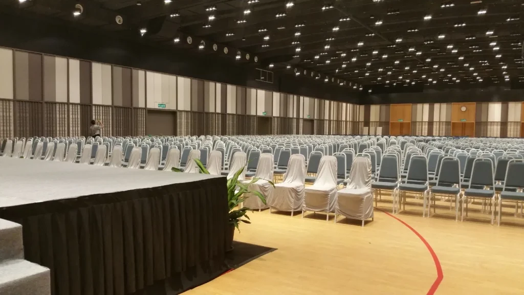 View from the edge of the stage across rows of conference chairs in the Multipurpose Banquet Hall