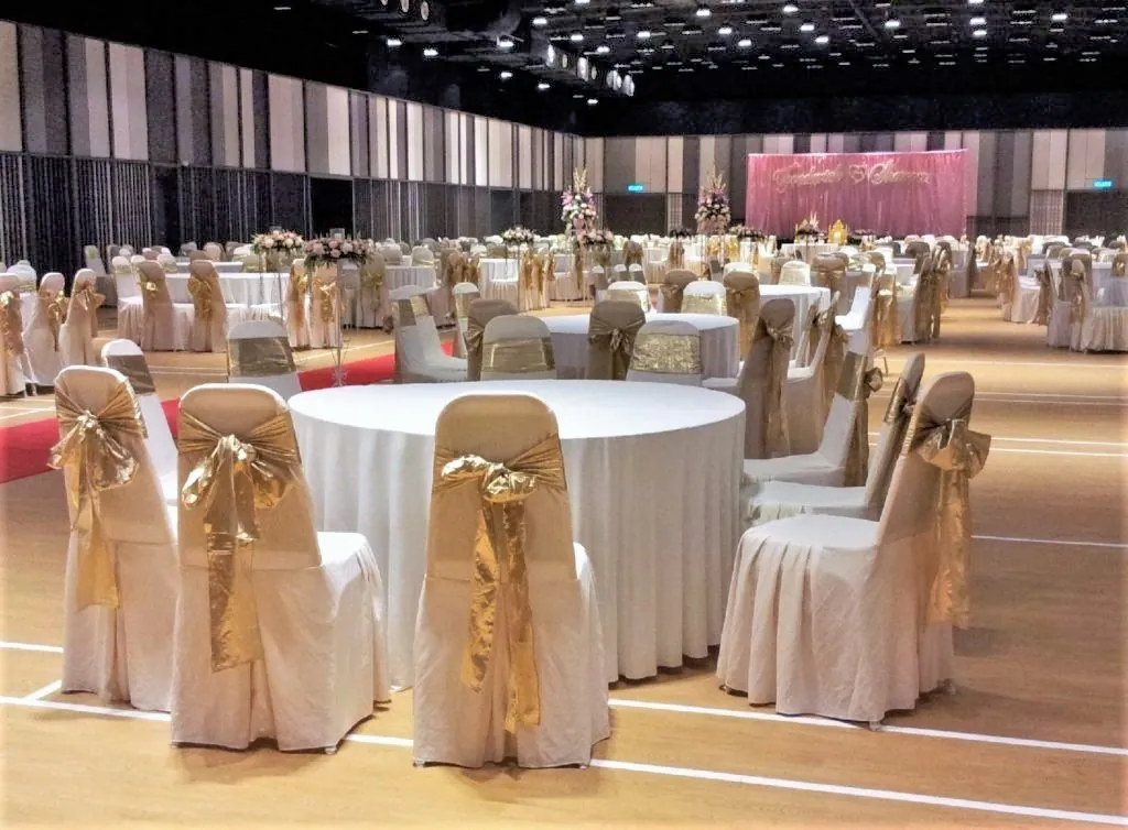 Close view of a wedding table with gold-sashed chairs in the Multipurpose Banquet Hall