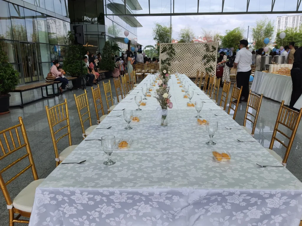 Long wedding table laid with glasses and flowers in the Plaza