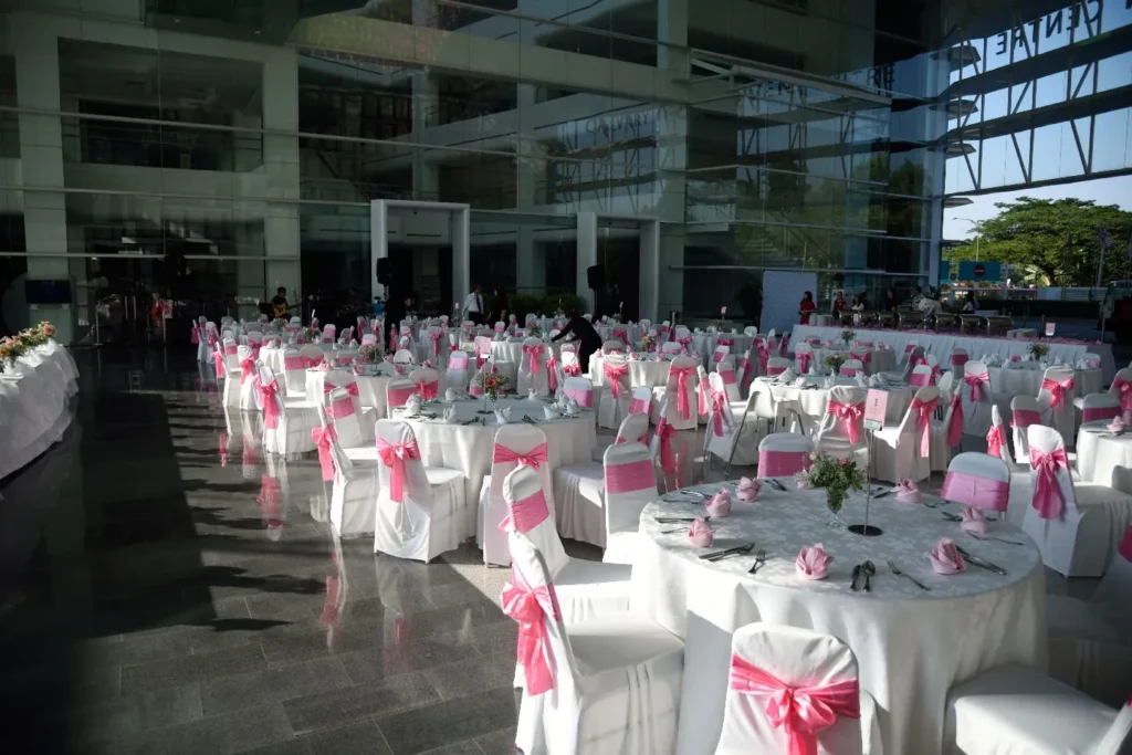 Wedding banquet tables with pink chair sashes in the Plaza