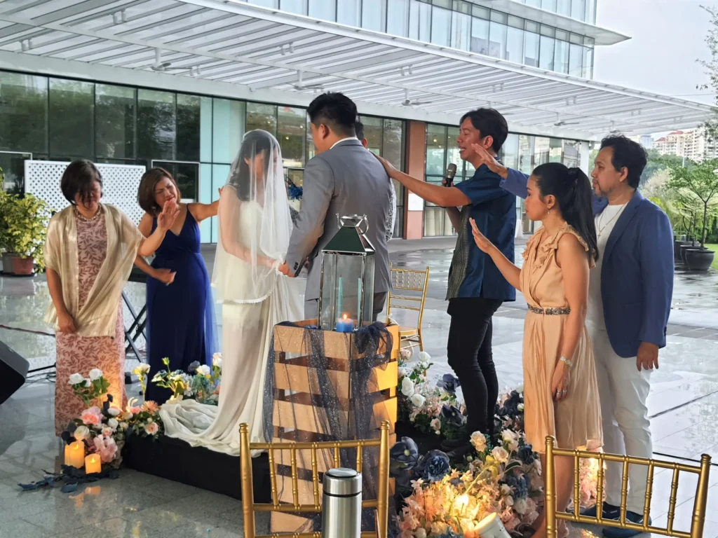 Family members blessing a bride and groom at a wedding in the Plaza