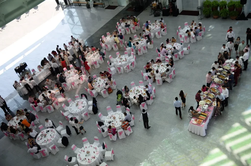 Wedding reception tables with pink sashes and a buffet line, seen from above in the Plaza