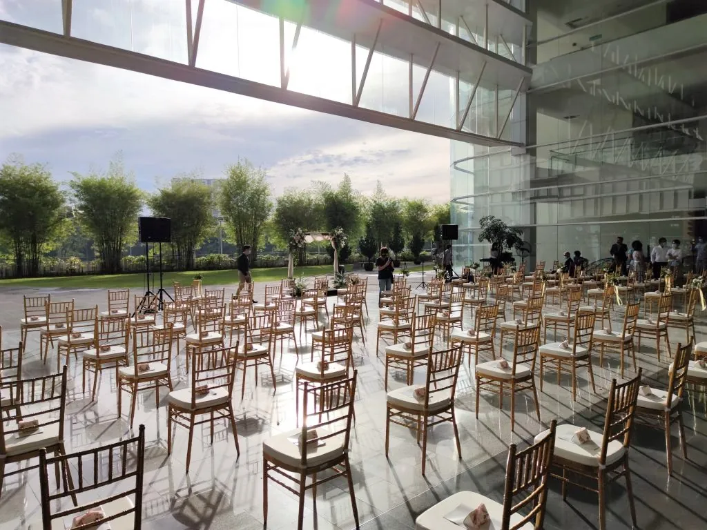 Rows of gold chairs set for a wedding ceremony at the edge of the Plaza, facing the lawn
