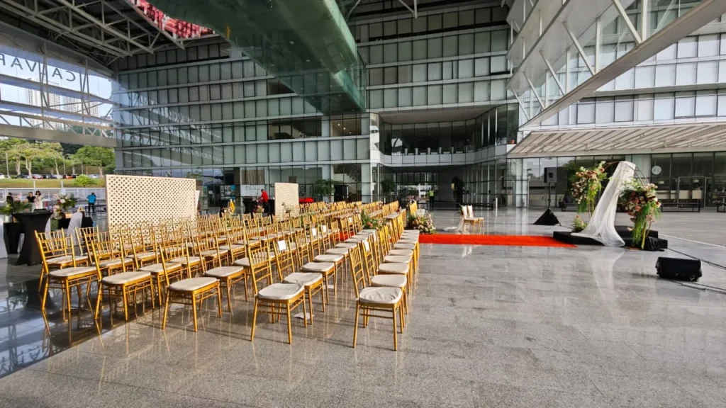 Rows of gold chairs facing a wedding ceremony area in the Plaza