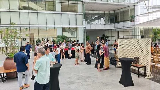 Wedding guests mingling around cocktail tables in the Plaza