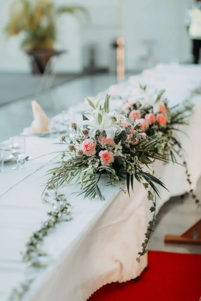 Pink and white flowers along a wedding table in the Plaza