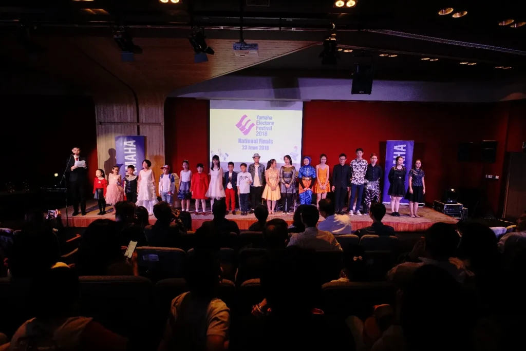 Performers and organisers on the Theatrette stage at the end of the Yamaha Electone Festival