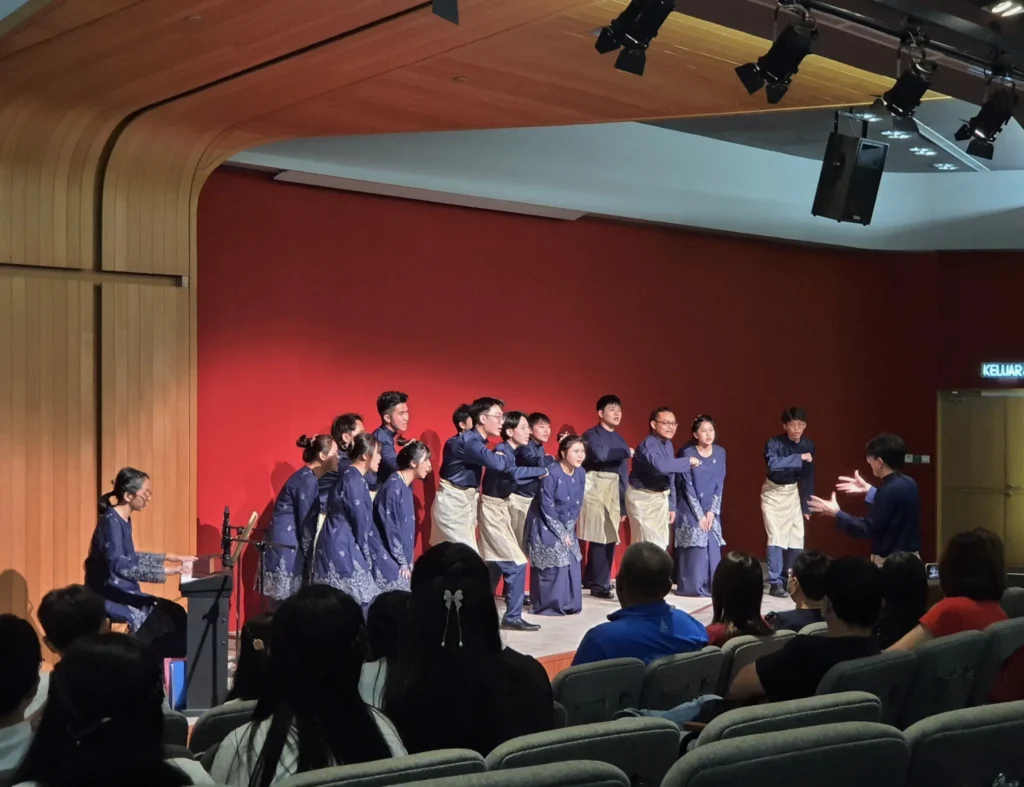 Choir singing with a pianist at the Elysian Concert in a Theatrette