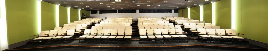 Wide view of the empty seating in a Theatrette with green walls