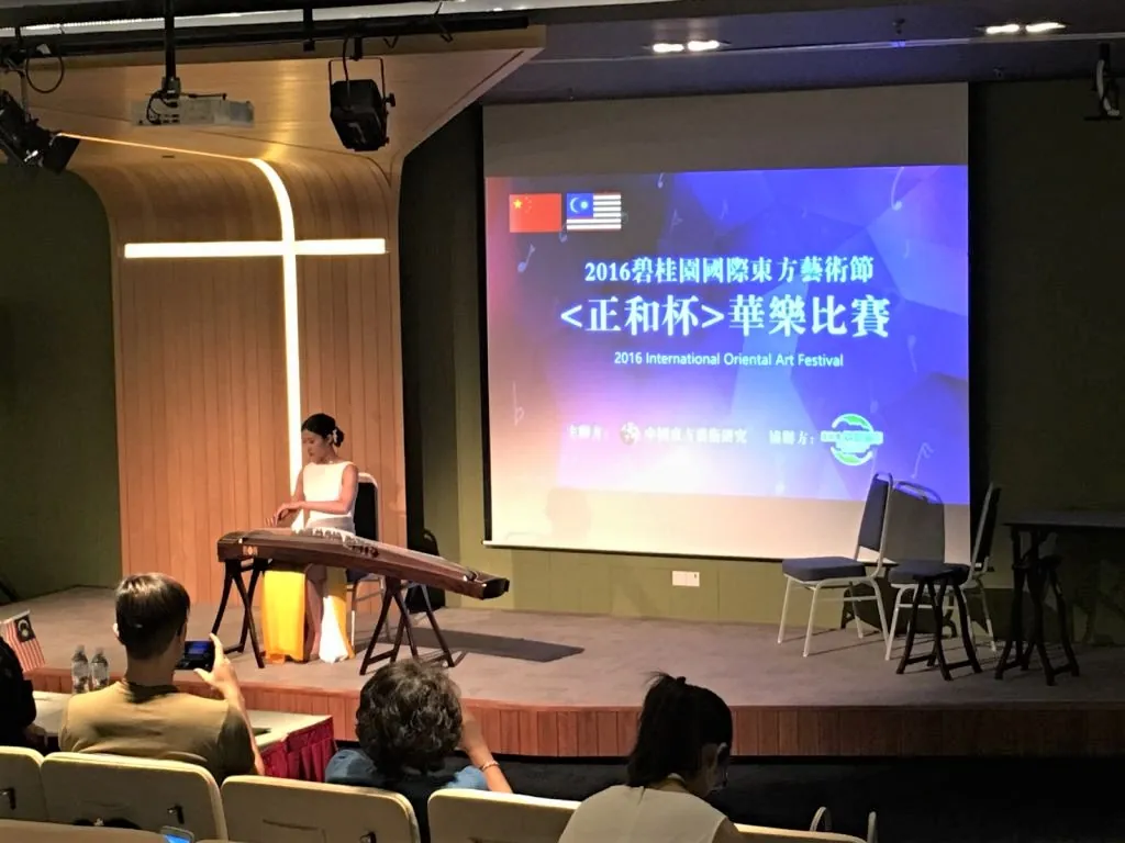 Guzheng player on a Theatrette stage at the 2016 International Oriental Art Festival