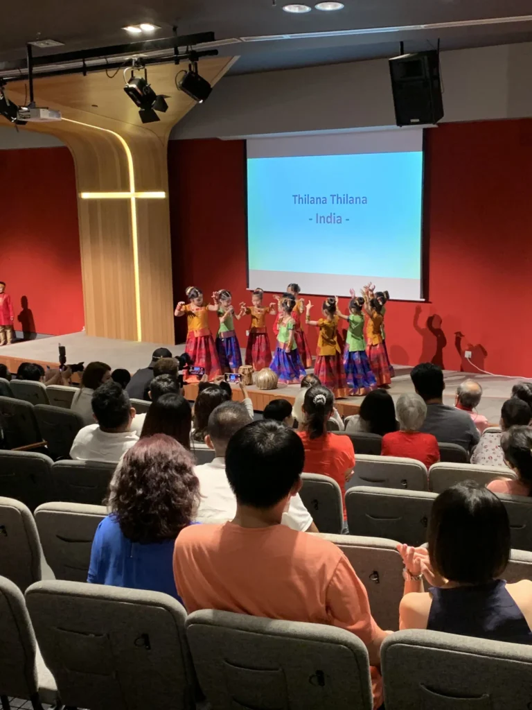 Children in costume dancing on a Theatrette stage at a kindergarten concert
