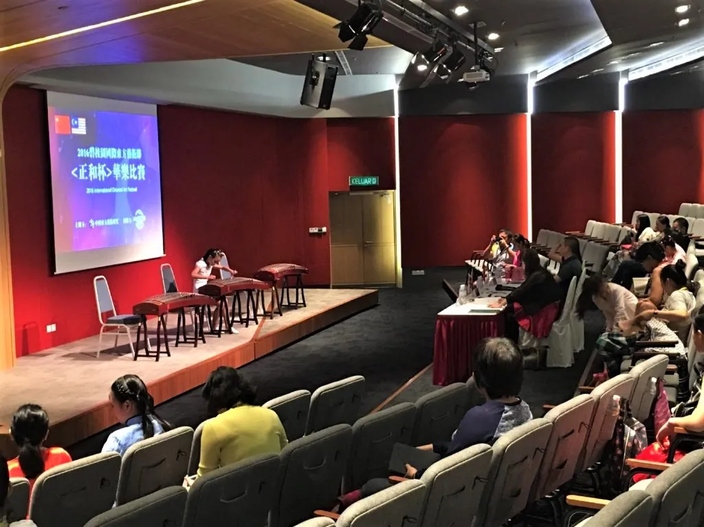 Judges' table and audience at the International Oriental Art Festival competition in a Theatrette