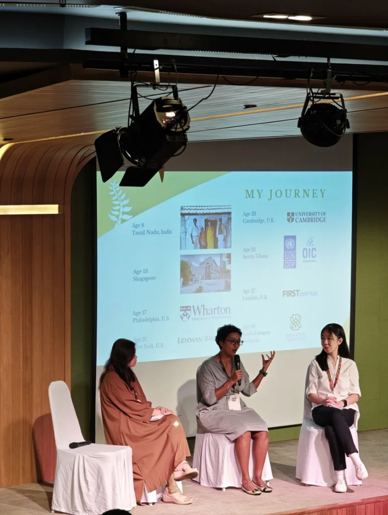 Three women speaking on a panel on a Theatrette stage