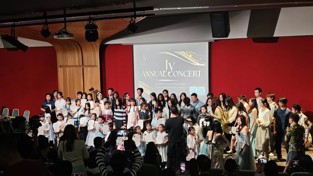 All the performers on stage for the finale of a music academy's annual concert in a Theatrette
