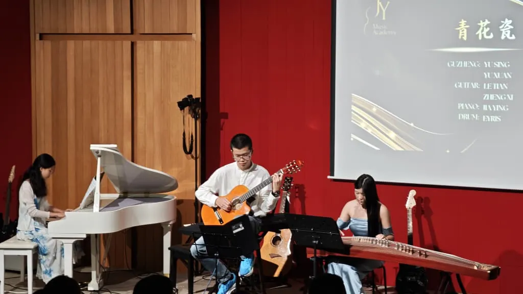 Piano, guitar and guzheng trio at a music academy recital in a Theatrette