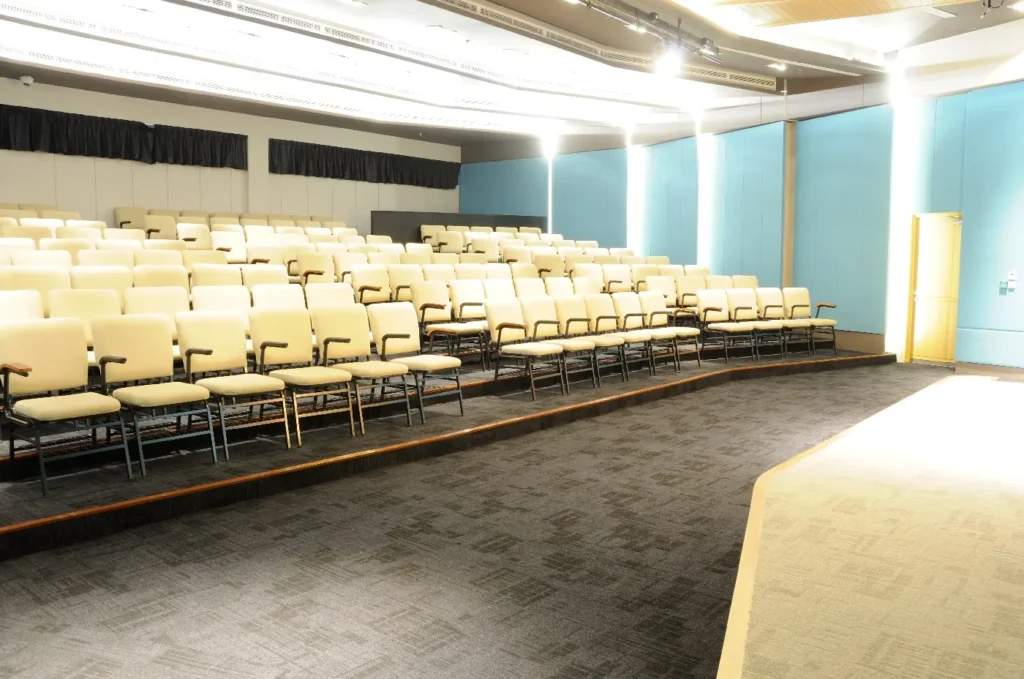 Tiered seats in a Theatrette with blue walls