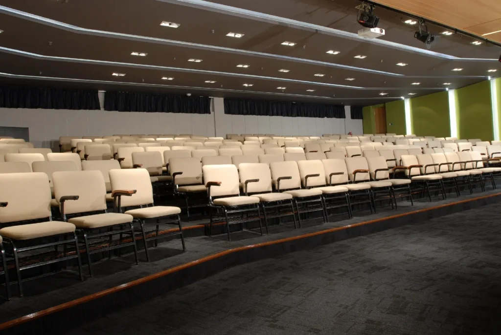 Tiered rows of cream seats in a Theatrette